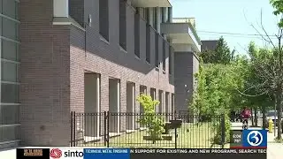 Teachers and parents discuss safety concerns outside a New Haven school