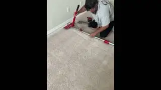 Setting up the power stretcher to stretch some carpet