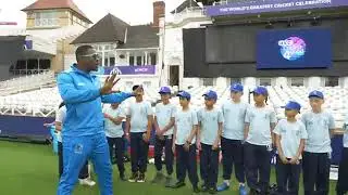 Cottral trains  his salute to a group of childran.