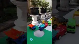 Big truck pushing mini car,dump truck and ambulance car into pit