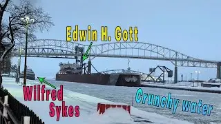The Edwin H Gott has to wait while the Wilfred Sykes sneaks through the ice into the Soo Locks