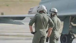 Ground crew kneeling near landing gear