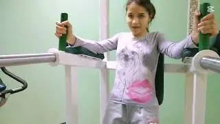 Medical Teacher Guides Young Girl in Therapeutic Gymnastics | Educational Health Training