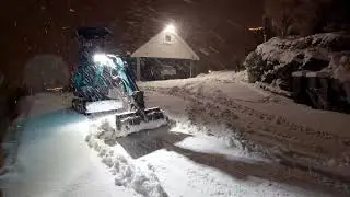Moving heavy snow at night with the mini excavator