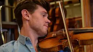 Violinists choose their instruments from the Musical Instrument Bank