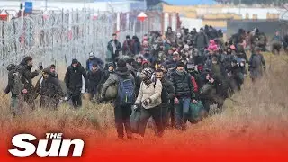 Lithuanian guards watch as migrants try to cross border into Poland
