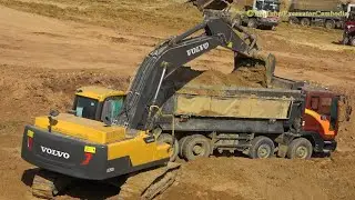 Volvo EC250DL Excavator Digging Loading Deawoo Dump Truck. 1080HD Video.
