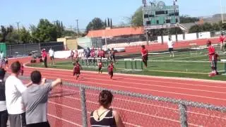 Hollis running the 100M getting first place