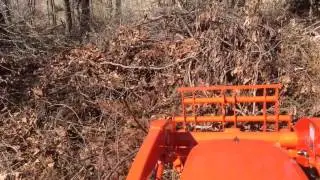 Kubota BX with forks, picking up some brush