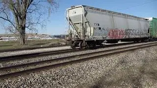 The long string of cars is coupled to the flat cars, then pushed back by CN 5483 at Pavilion, MI