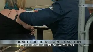 Health officials urge caution after slight rise in COVID hospitalizations