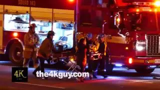 4K UHD - Emergency team carrying stretcher while doing CPR on car crash victim
