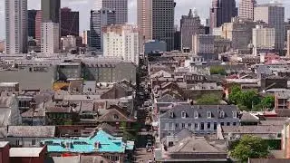 Vibrant rooftops and historic architecture of New Orleans' French Quarter, set against the towering