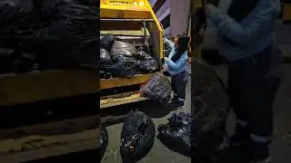 girl learning to compact garbage in the garbage truck