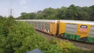 CP unit 9822 leads mixed train past the MacLennan footbridge