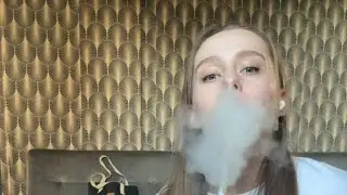 beautiful girl smokes hookah enjoys it and coughs