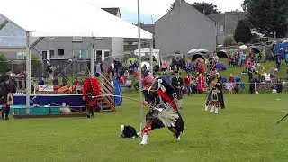 Chieftain joins Drum Majors Mace throw over banner competition during 2024 Dufftown Highland Games