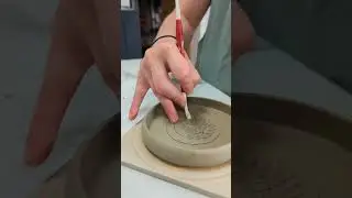Pottery artist is decorating a garlic grater!