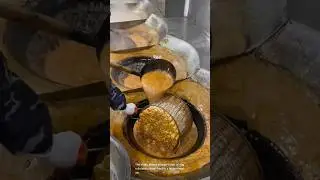 Egg rolls deep frying in a big pan