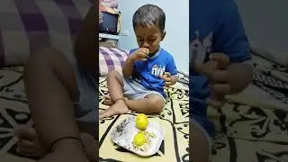 Cute boy eating lemon.....