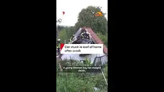 Car stuck in roof of home after crash
