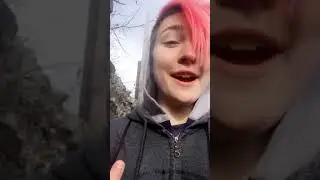 German news reporter speaks with the Berlin Wall