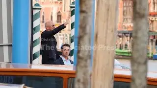 Multi-billionaire Amazon founder Jeff Bezos and Lauren Sanchez wave as they board a Venice water tax