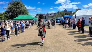 Drum Major leads Ellon RBL Pipe Band march into the 2025 Aboyne Highland Games in Deeside, Scotland