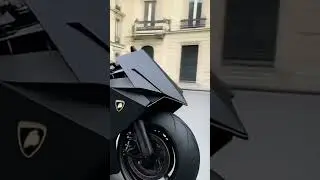 This Lamborghini motorcycle features futuristic lines, carbon fiber bodywork,