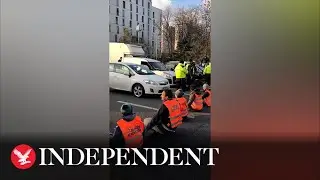 Angry motorists honk horns as climate activists block busy Paris road