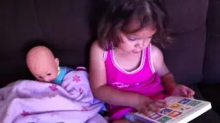 Ayala reading to her baby