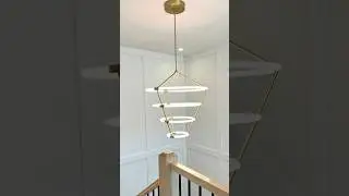 Installing board & batten by staircase with 4 tier chandelier #stairs #chandelier #staircase