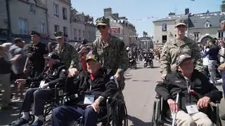US veterans given hero's welcome as they parade through Normandy town as part of D-Day ceremonies