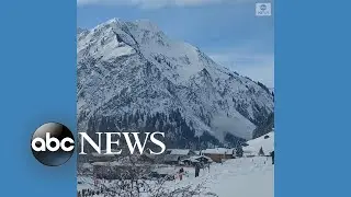 Controlled avalanche sends snow down mountain