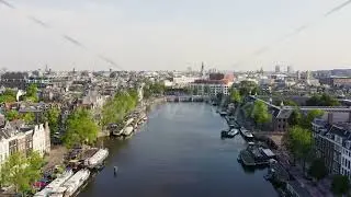 Amsterdam, Netherlands. Flying over the city rooftops. Amstel River, Amstel Gateways, Aerial View Hy