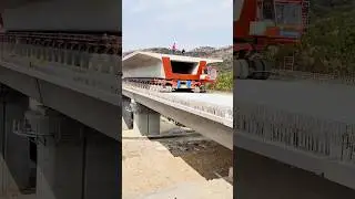 Transporting prefabricated high-speed rail bridge beams using a beam carrier vehicle