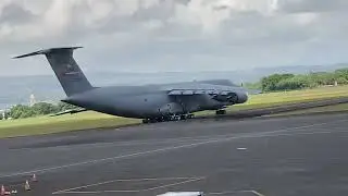 Large Military Plane Moving On The Runway at Hilo International Airport in Hawaii.