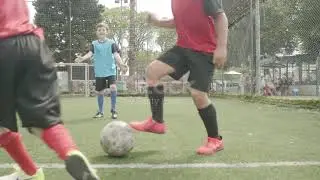 Soccer team of kids playing football with their coach 4K stock video...