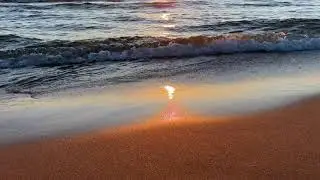 3 minute visual meditation of sunset reflected on waves lapping the beach with ambient sound in 4K