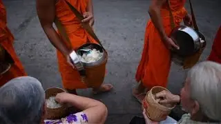 Alms-giving ceremony for Buddhist monks in Luang Prabang