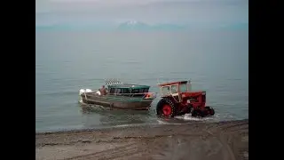 How tractor pulls a boat out of the water onto the beach