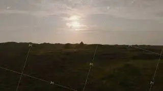 Sunlight bathing a lone building in the Ringkobing Fjord landscape during sunset highlights Denmark