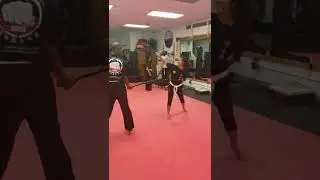 Students Jade and Terrence practice brand new stick fighting skills at Ancient Arts Kuk Sool Kwan