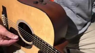 Lou Begue tunes his acoustic