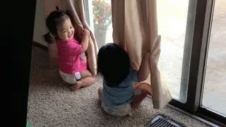 Twins play peekaboo