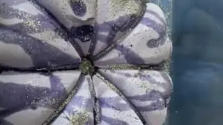 Periwinkle-lavender pumpkin bundt  drizzled with oil and dusted in sparkling silver glitter 💜🪩✨
