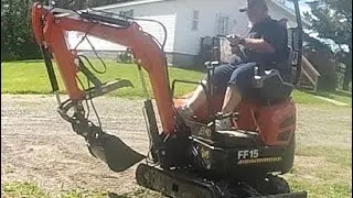 Using the mini excavator tilt bucket and siding for the garage.