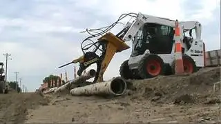 Mul T Rex multi-function skid loader attachment.