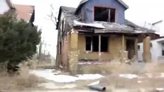 Michael Moore tells the truth (over footage of detroit)