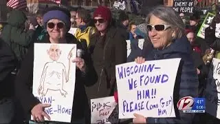 Local protesters gather to greet House Speaker Paul Ryan
